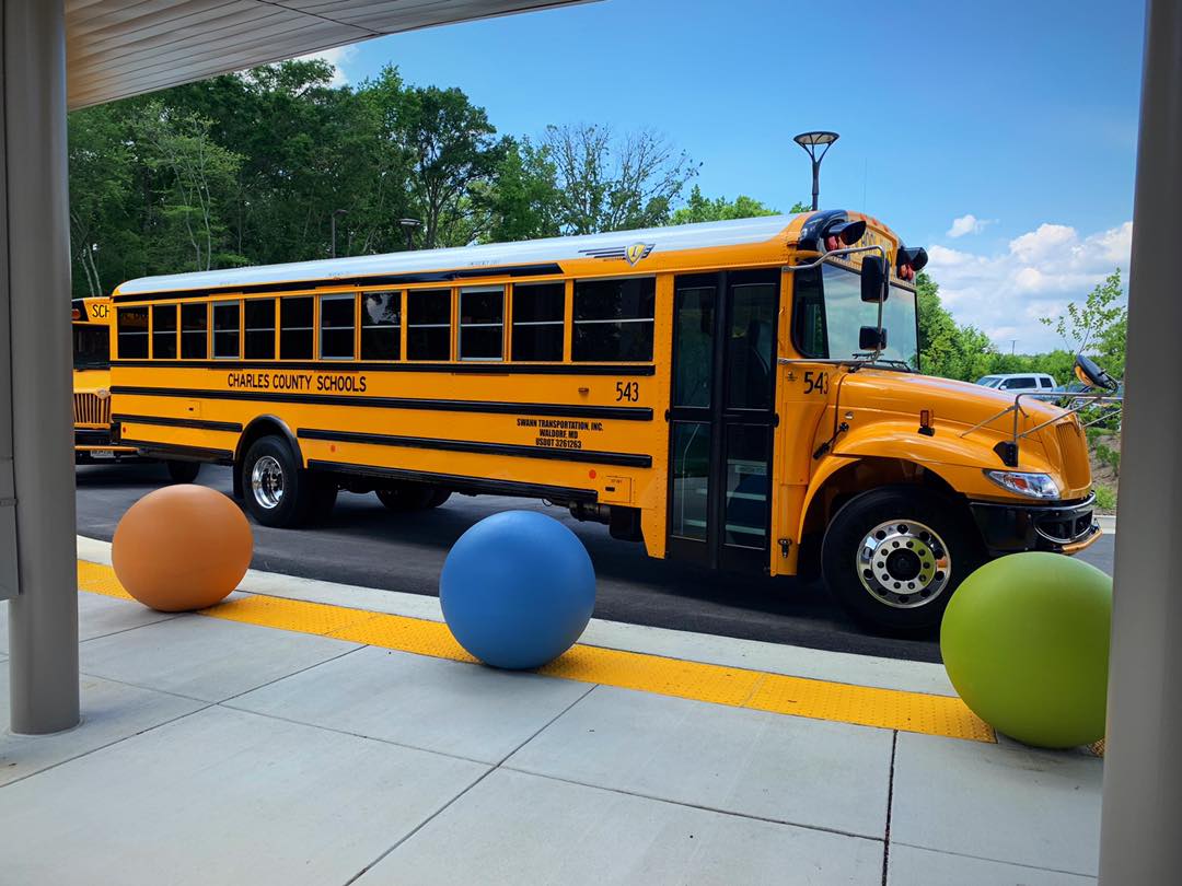 School bus parked in front of school.